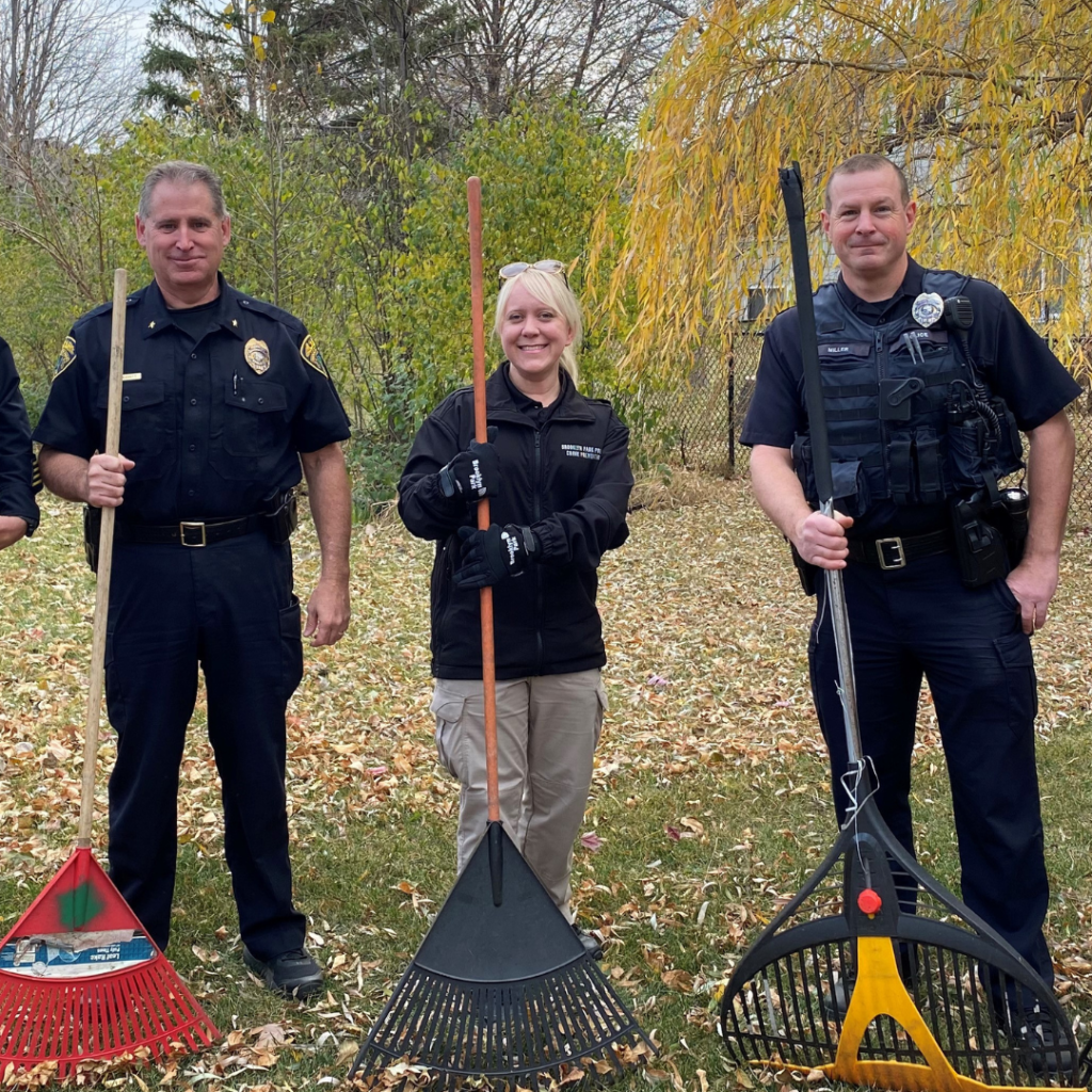 Group of police officers posing with rakes